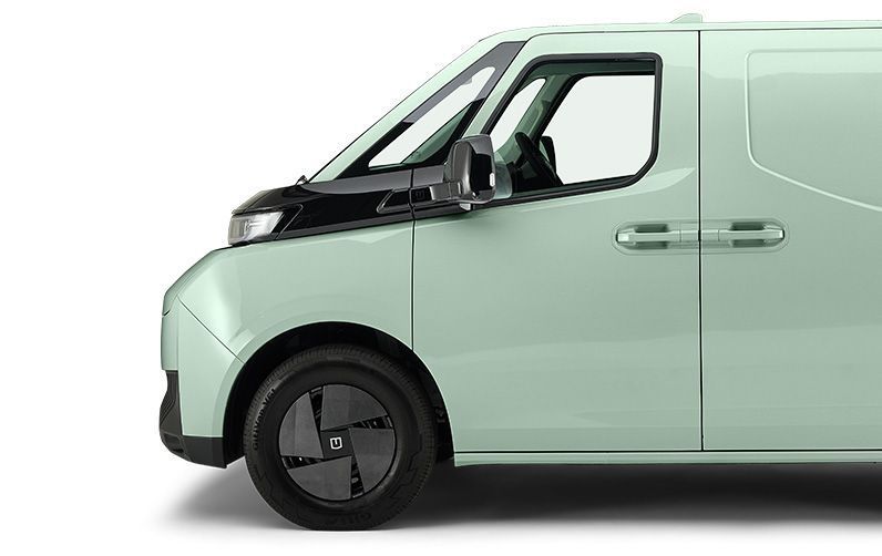 A side view of a light green, modern electric cargo van with a black front panel and black aerodynamic wheel covers.