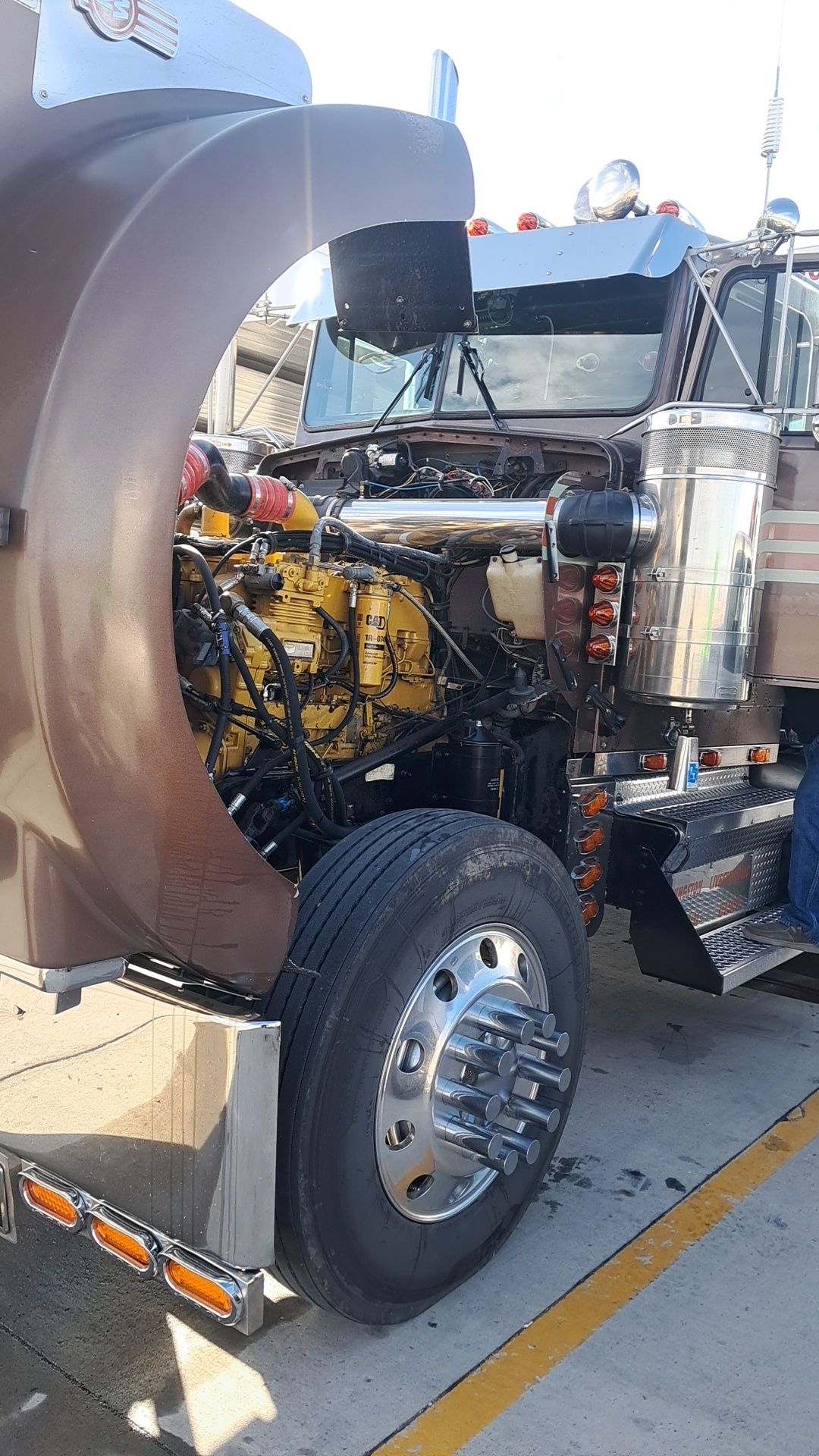 Semi-truck with open hood exposing the engine, parked outside on pavement | Doyle Diesel