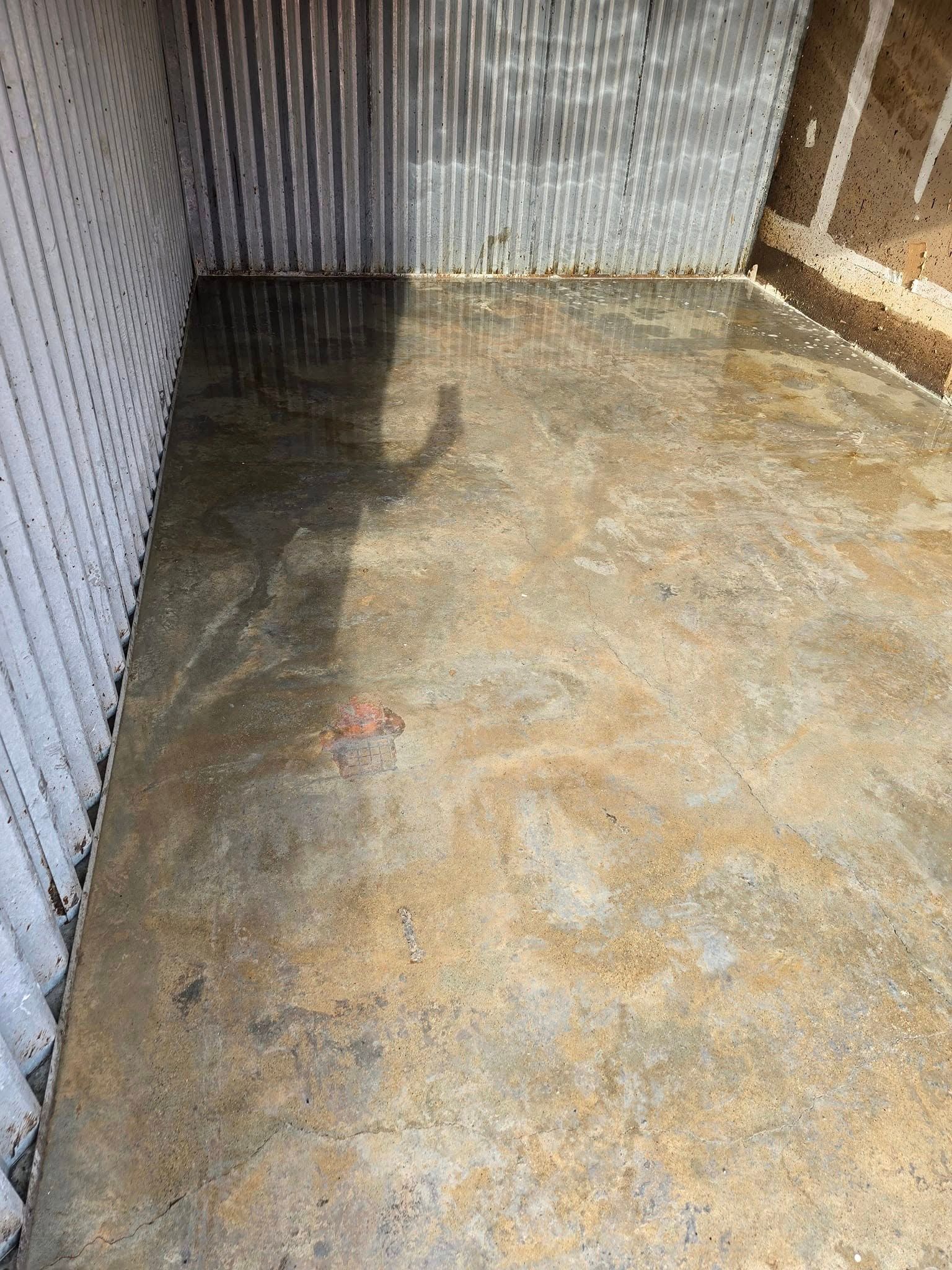 A dirty room with a shadow of a person on the floor.