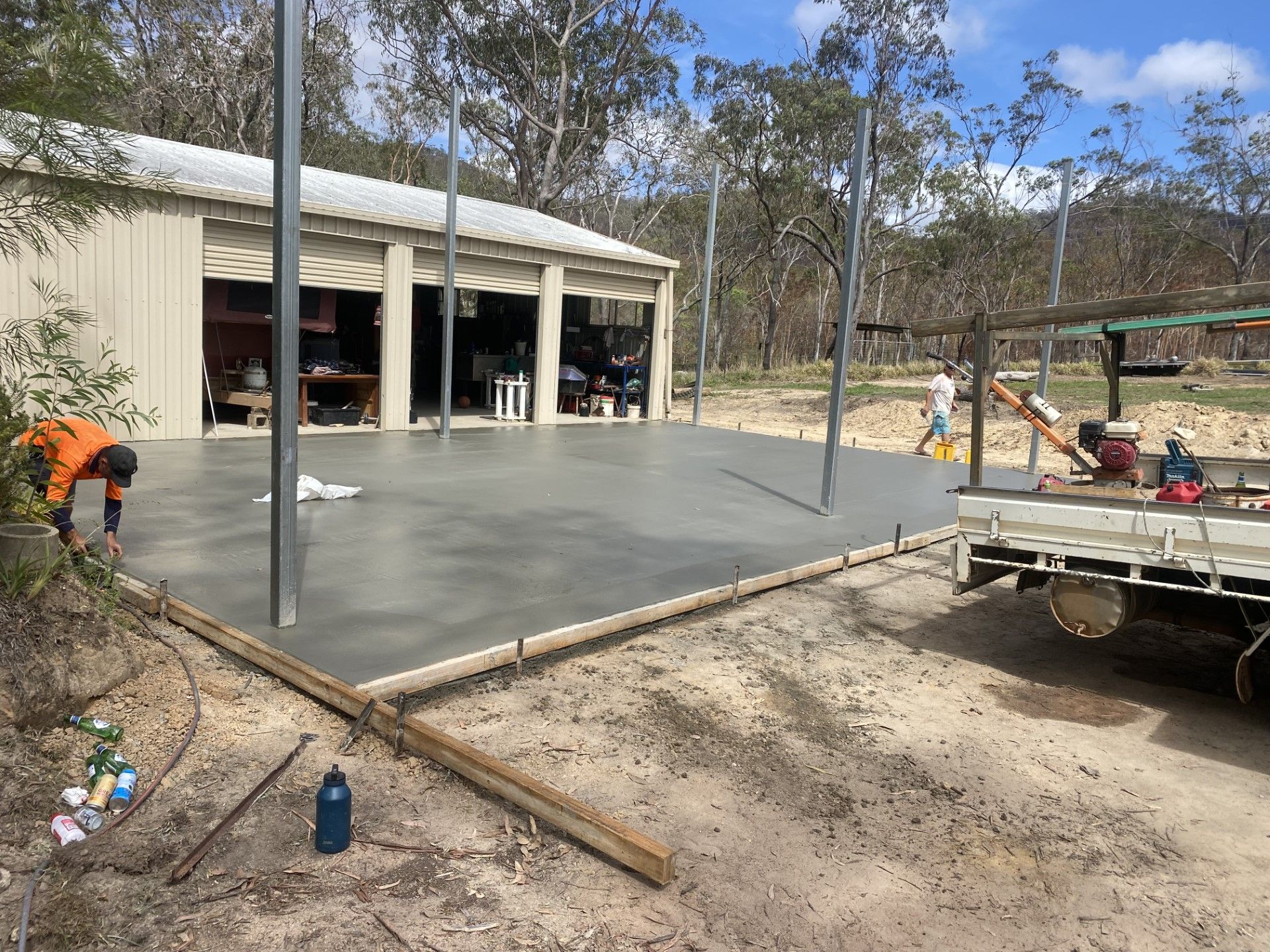 Two Builders Working On Laying A Concrete Driveway — Neil Stafford Concreting In Mareeba QLD 4880