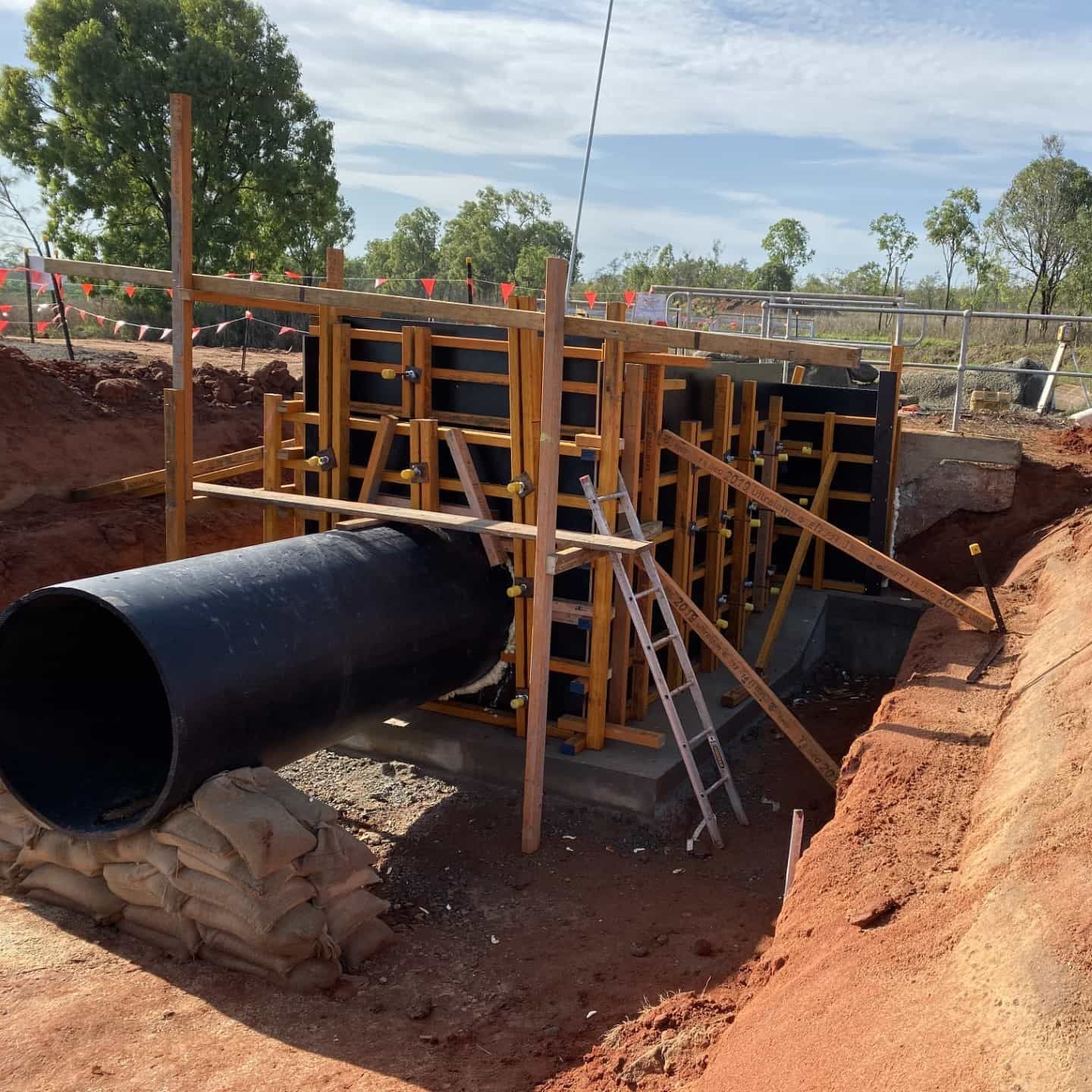 A Large Black Pipe Is Being Built In A Construction Site — Neil Stafford Concreting In Mareeba, QLD
