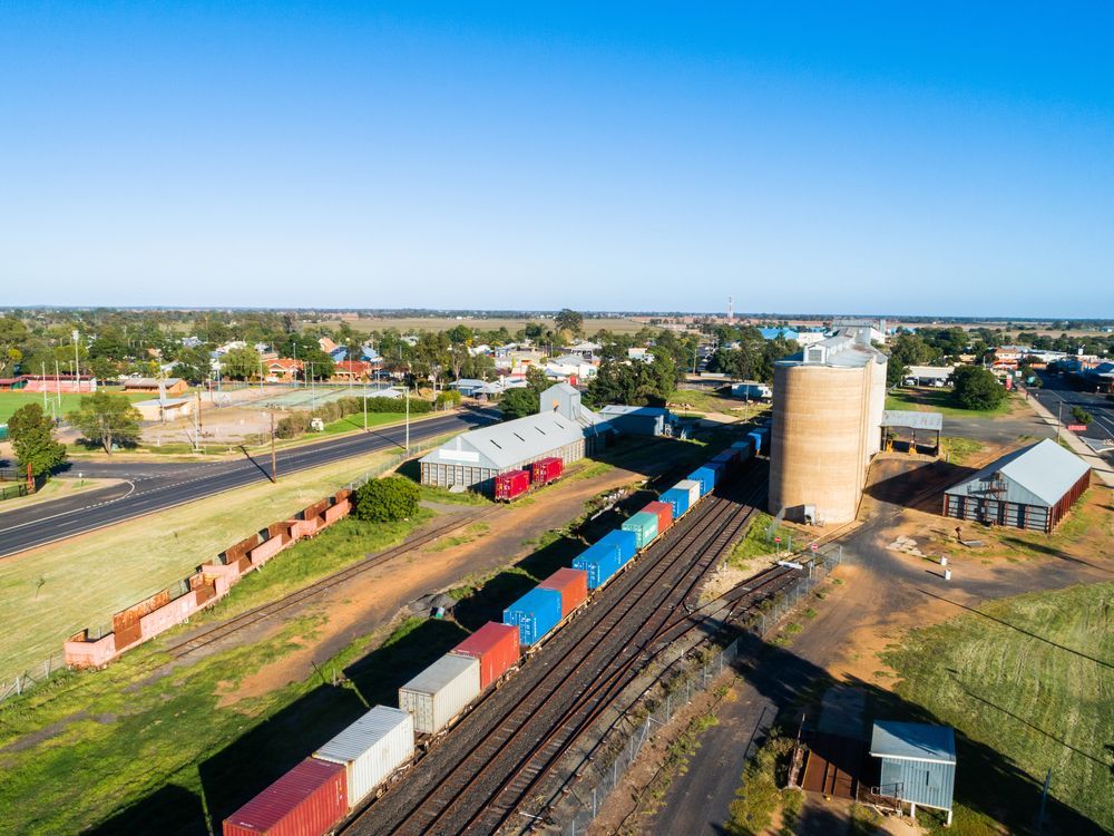 An aerial view of a train going down train tracks.