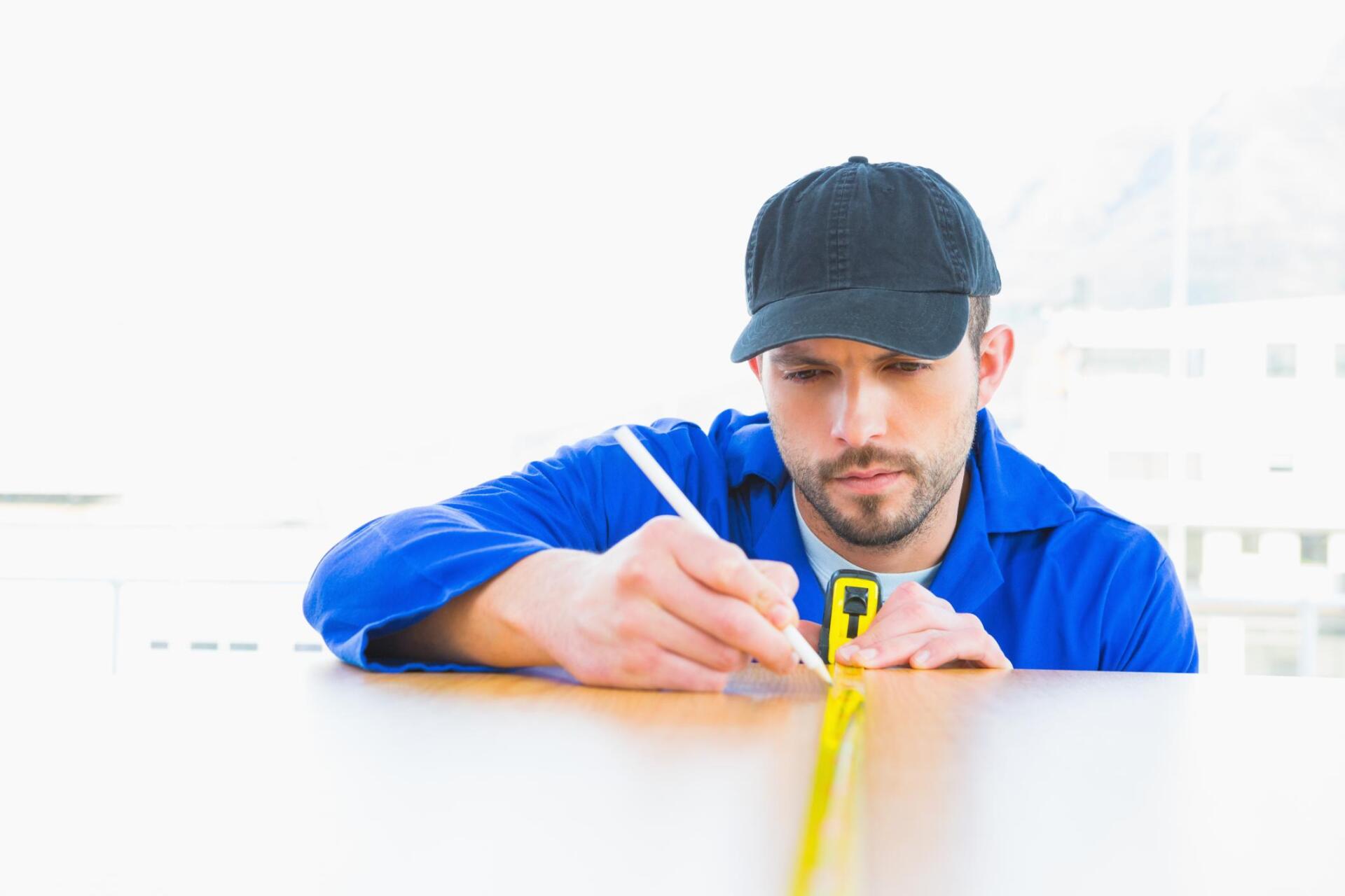 man measuring countertop