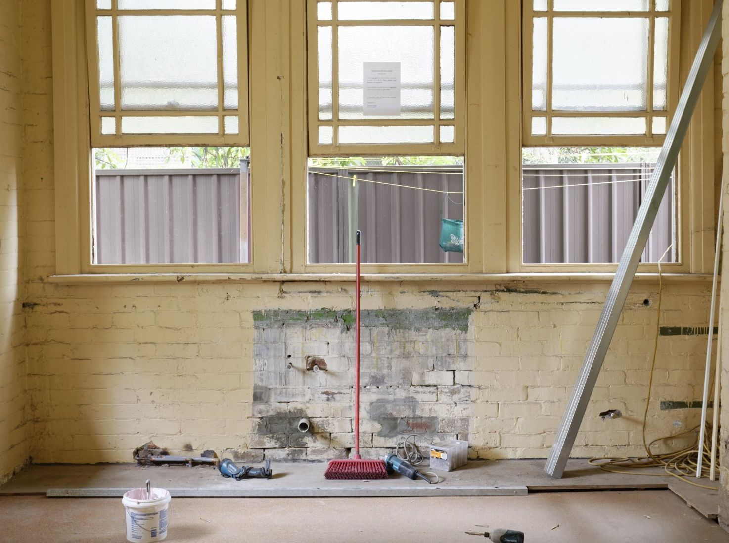 picture of window wall being repaired
