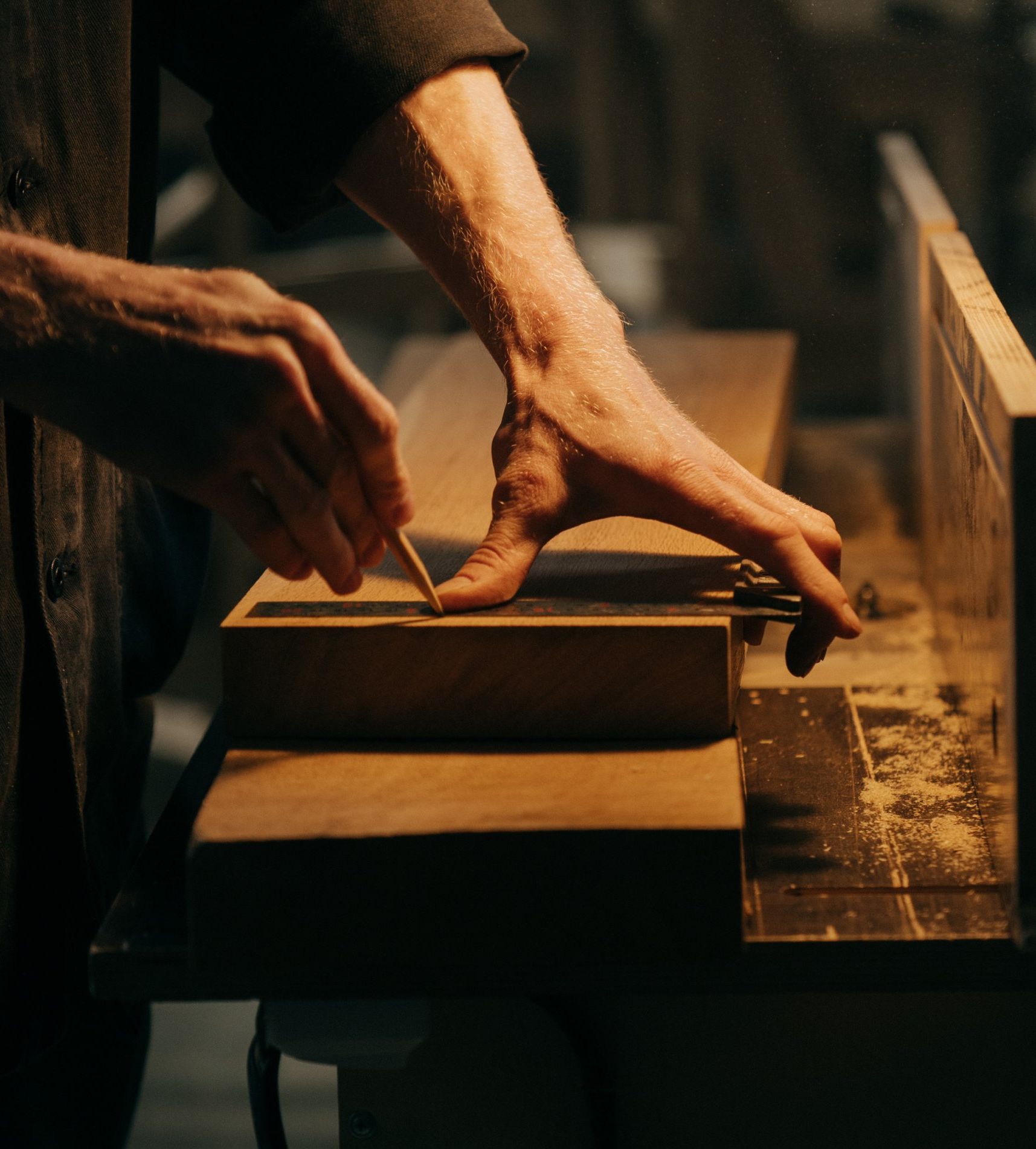 picture of man working on wood planks in shop
