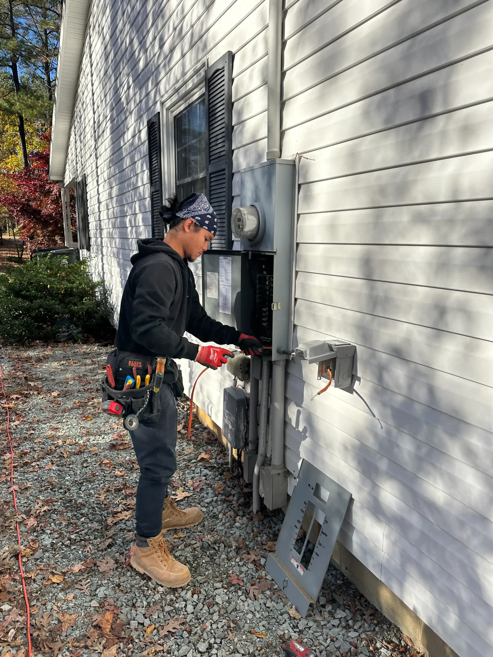 Licensed Greensboro electrician testing upgraded electrical panel