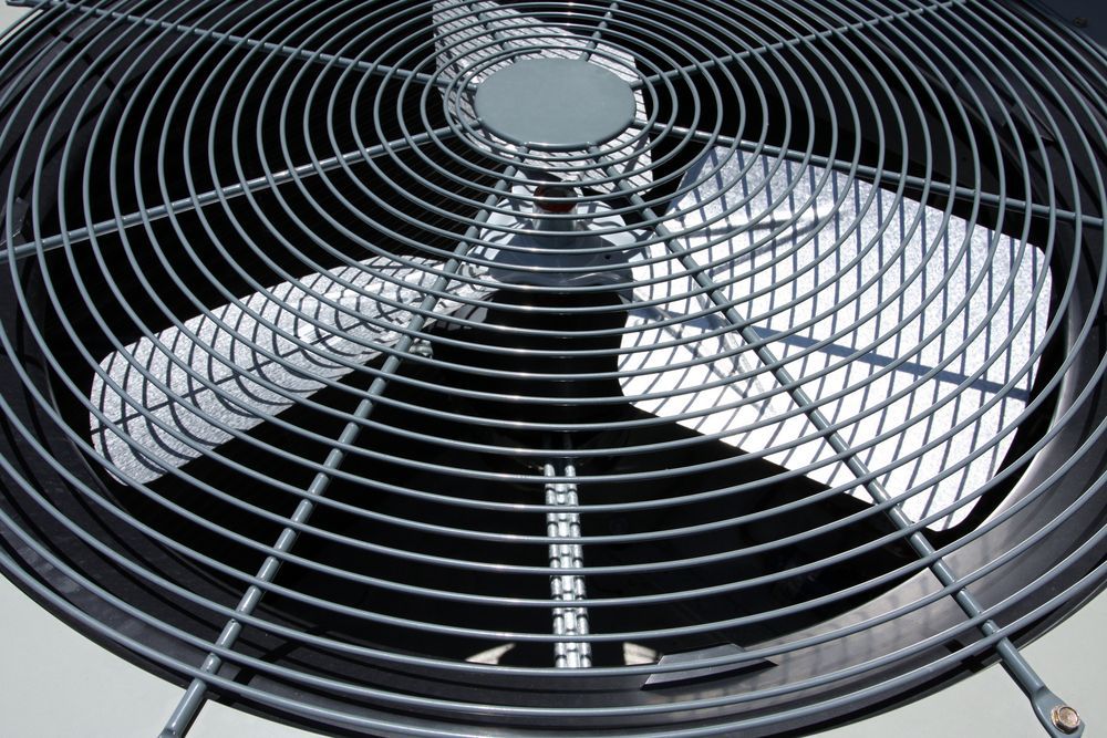 A close up of a fan on top of a building