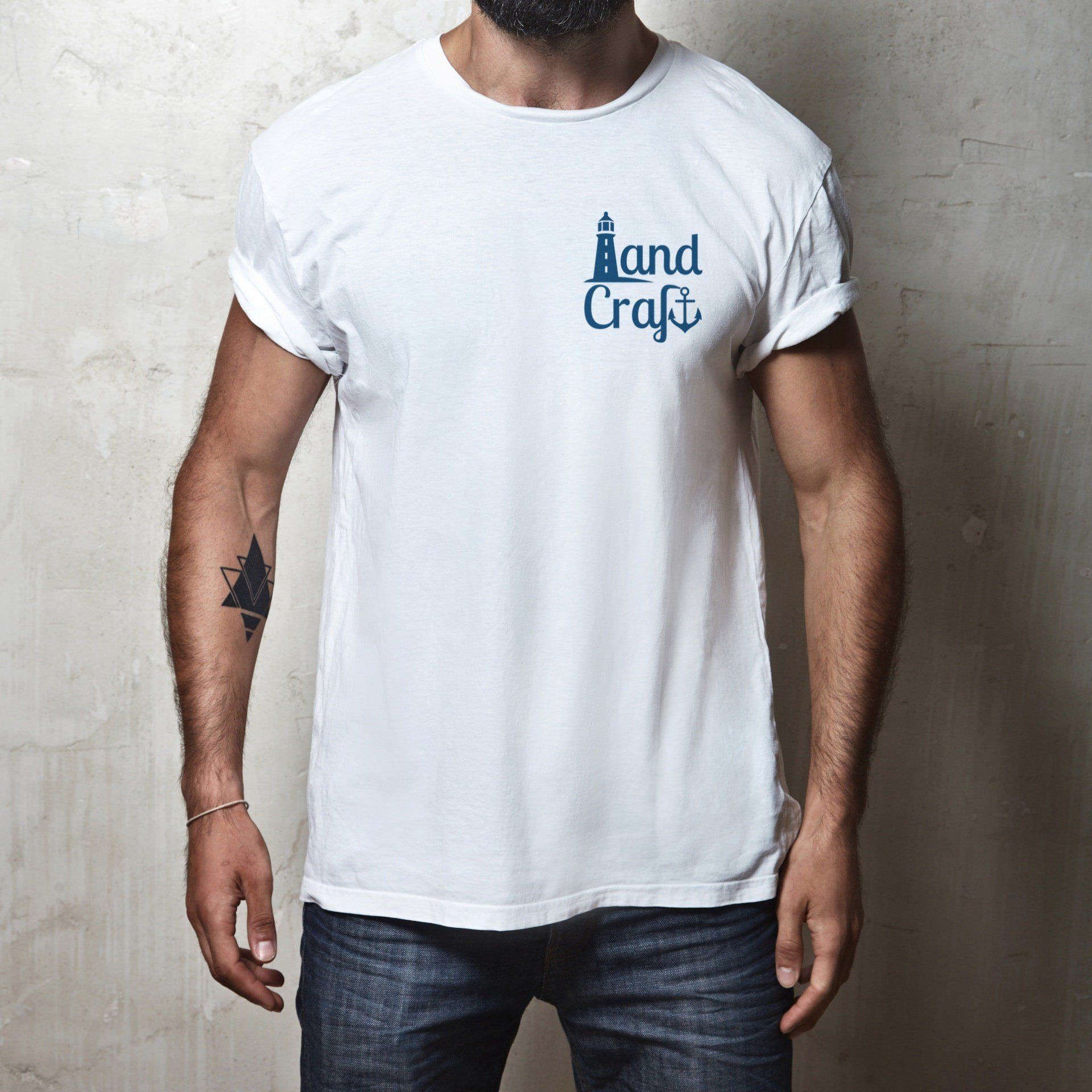 Person wearing a white tee shirt with a blue LandCraft logo