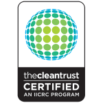 A black and white emblem with a globe made of green and blue dots, 