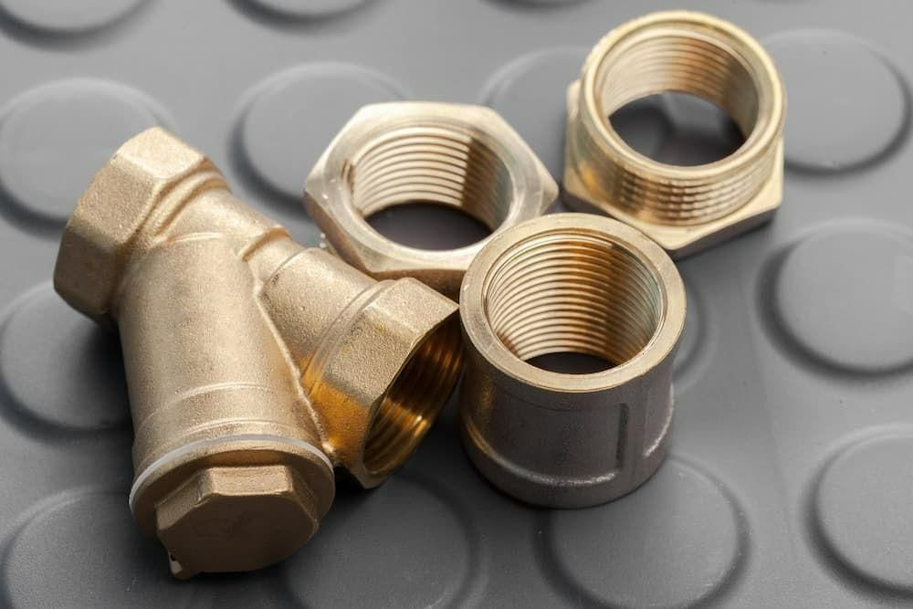 Brass Pipe Fittings And Nuts On A Rubber Mat — Torque Tech Supply & Repairs In Kempsey, NSW