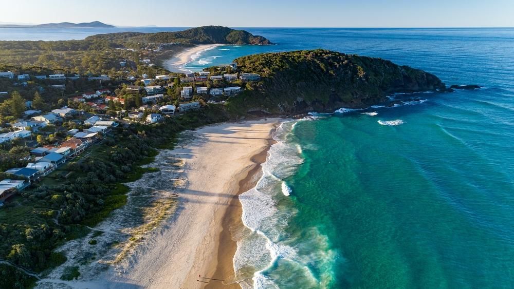 An Aerial View Of A Beach And Ocean With Waves Crashing On The Shore — Torque Tech Supply & Repairs In South West Rocks, NSW