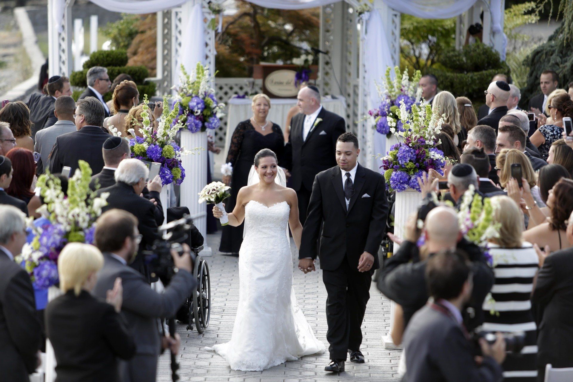 a newly married couple walking down the aisle together at Marina Del Rey