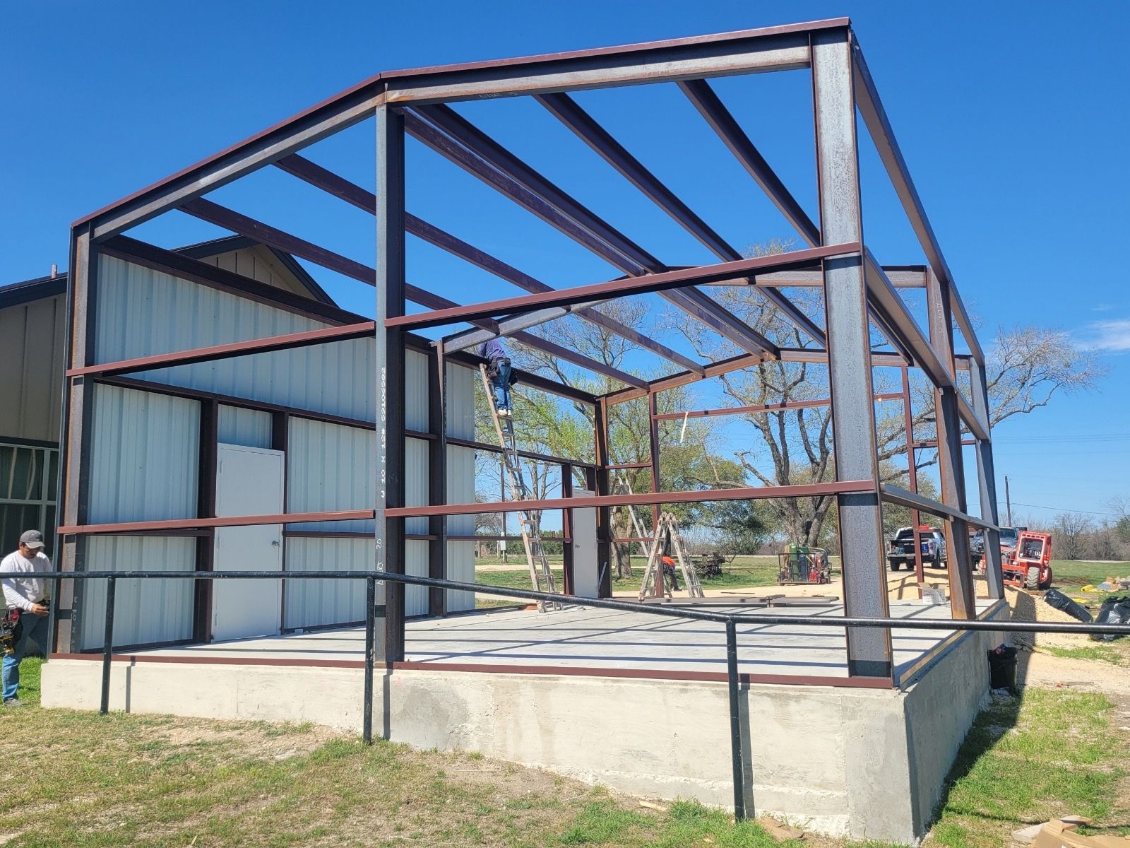 A large metal structure is being built as an addition for storage