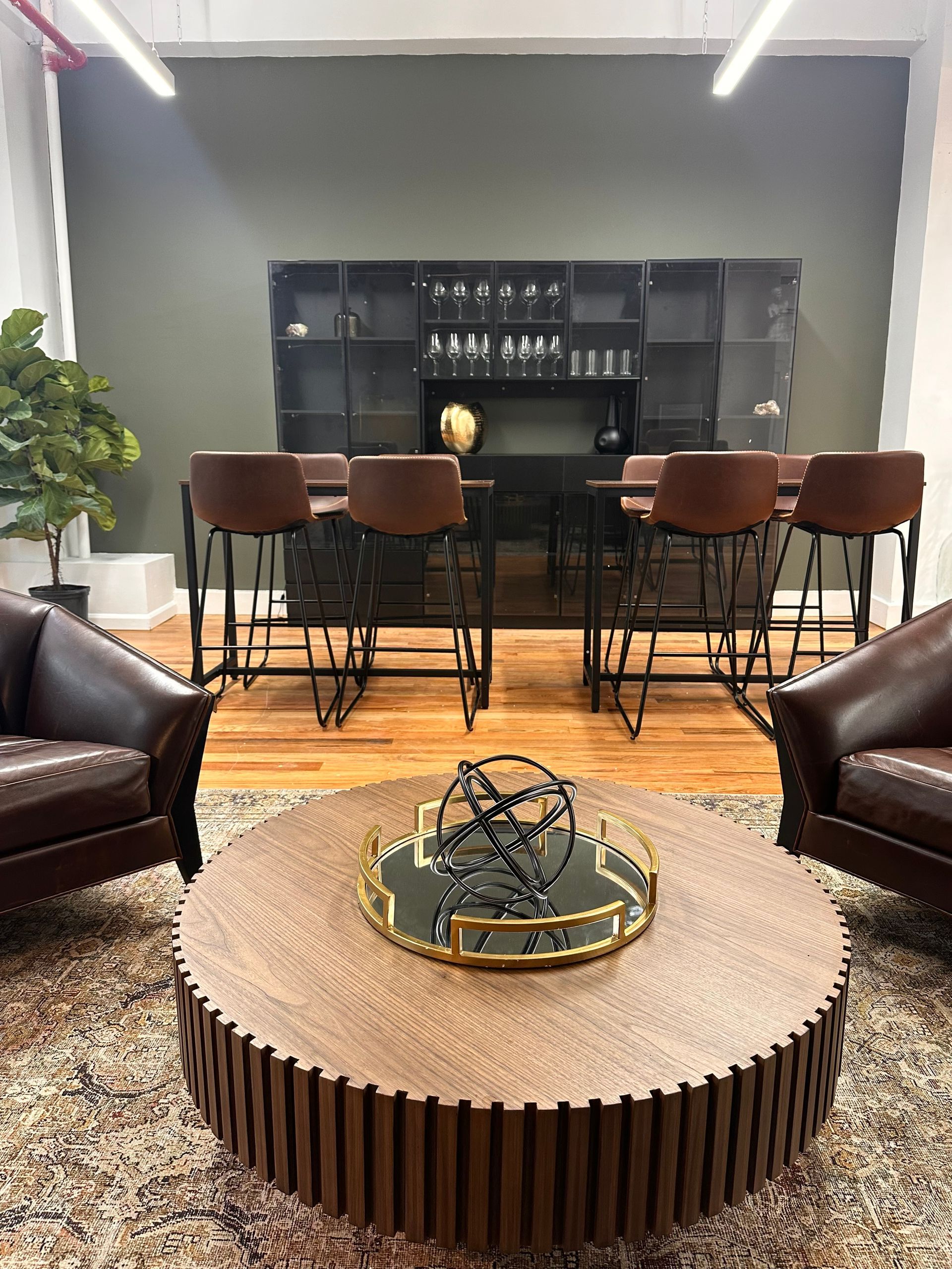 A living room with a round coffee table and chairs