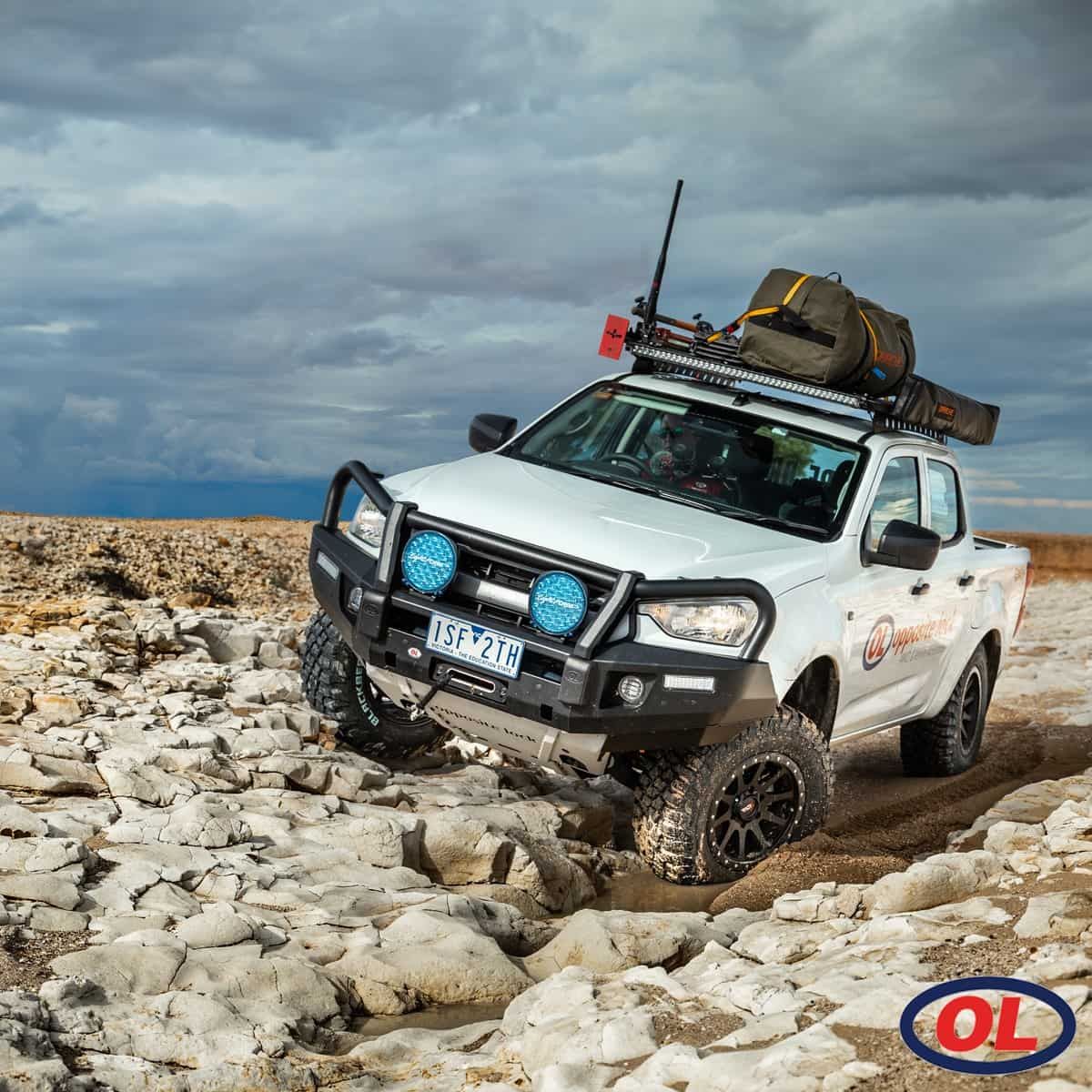 A White Truck Is Driving Through A Rocky Area — Opposite Lock In Wodonga, VIC