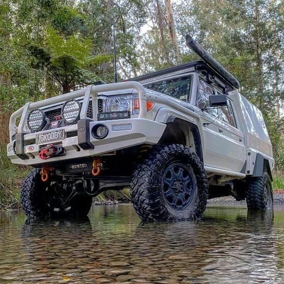 A White Truck Is Driving Through A River In The Woods — Opposite Lock In Wodonga, VIC
