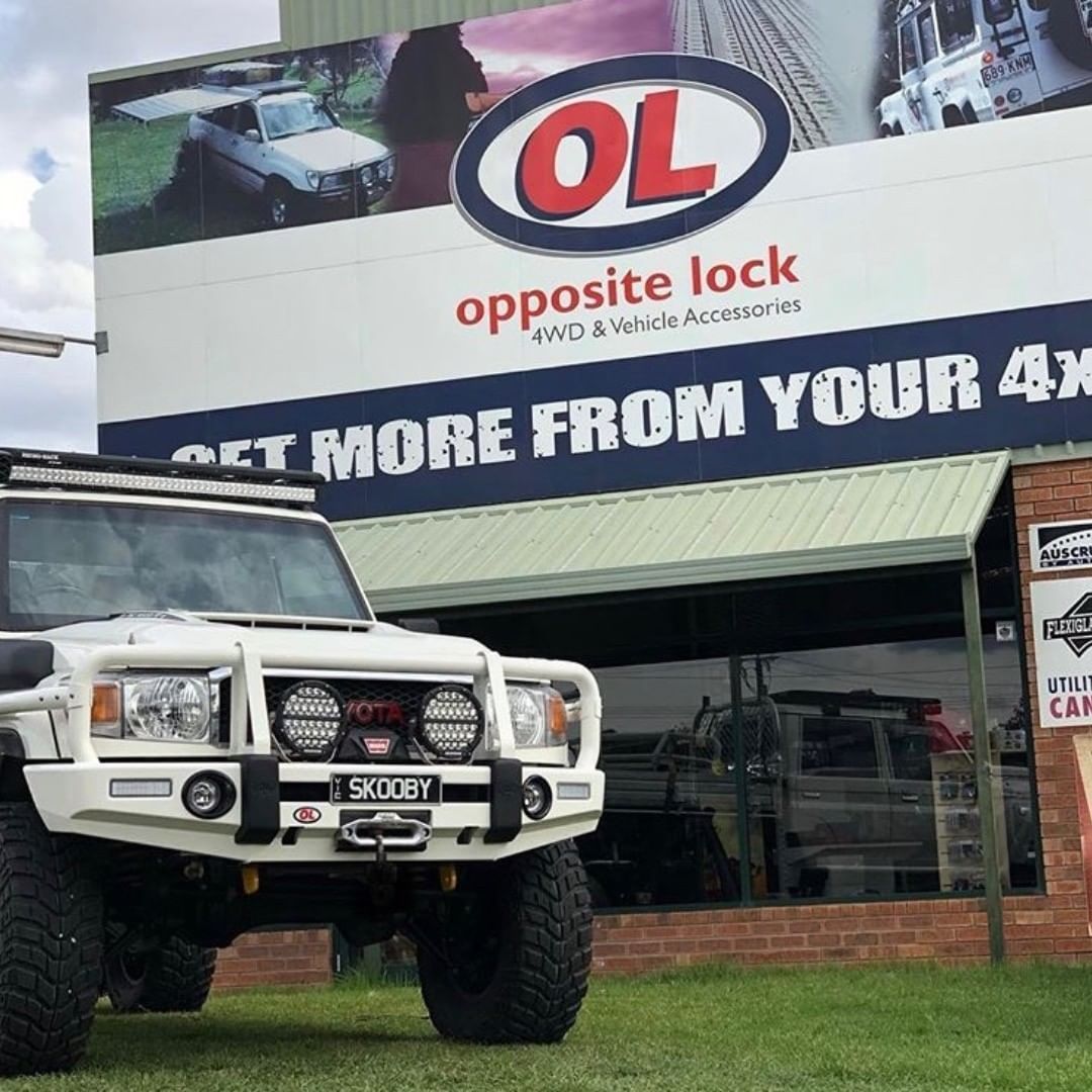 A White Truck Is Parked In Front Of A Building That Says Opposite Lock — Opposite Lock In Wodonga, VIC