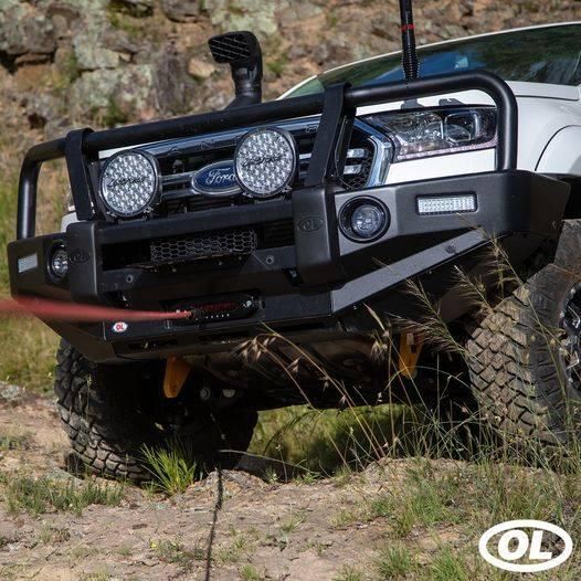 A White Truck Is Driving Down A Dirt Road With A Winch Attached To The Front Bumper — Opposite Lock In Wodonga, VIC