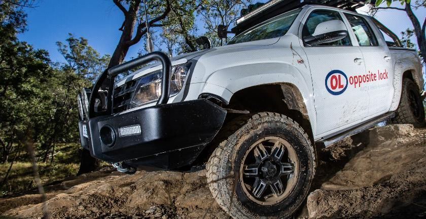 A White Truck Is Driving Down A Dirt Road — Opposite Lock In Wodonga, VIC