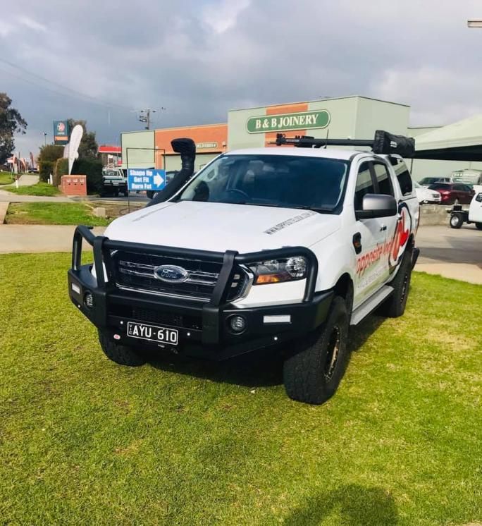 A White Ford Truck Is Parked In A Grassy Area — Opposite Lock In Wodonga, VIC