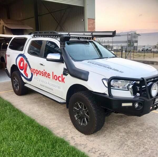 A White Truck With The Word Opposite Lock On The Side Is Parked In A Driveway — Opposite Lock In Wodonga, VIC