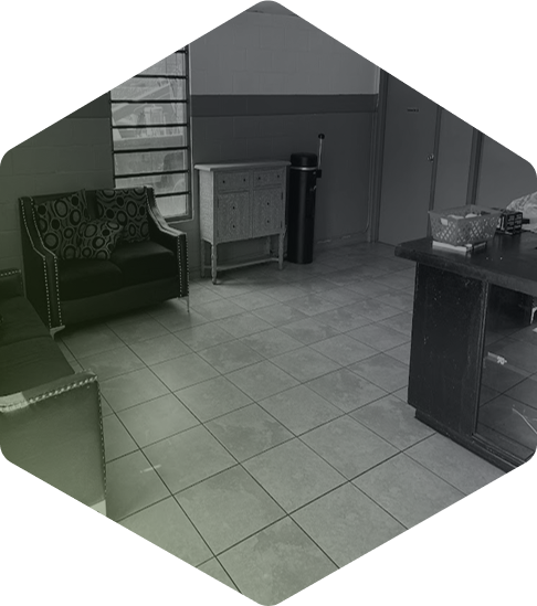 A black and white photo of a living room with a couch and chair.