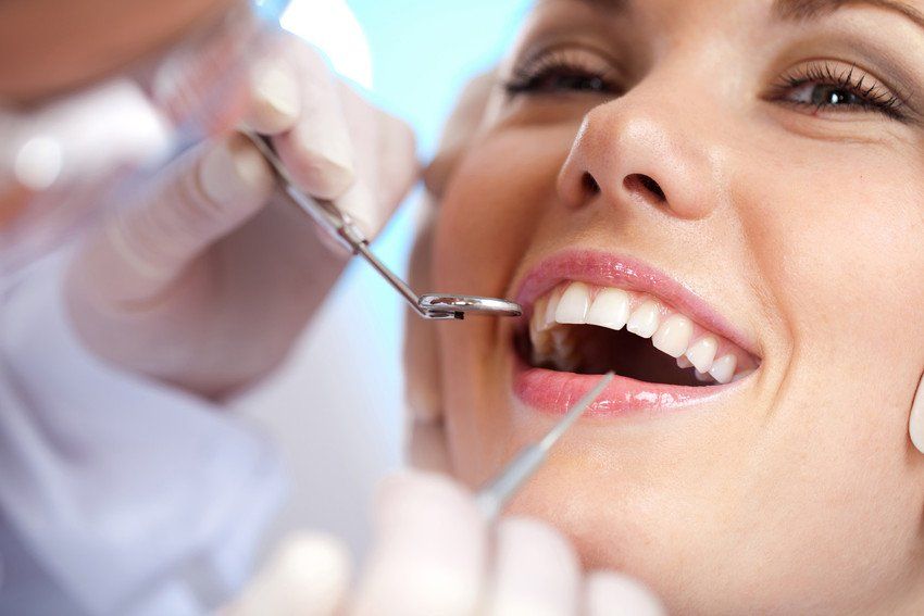 A young woman receives dental examination