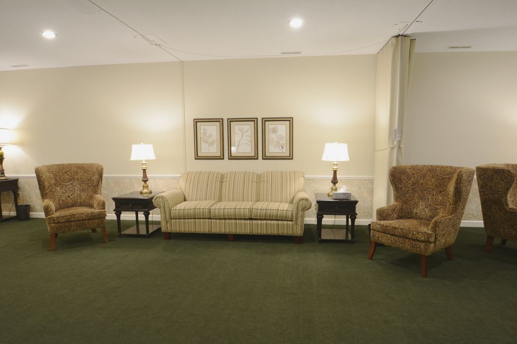 A living room with a couch and two chairs