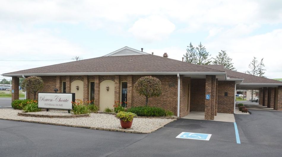 A brick building with a handicapped parking spot in front of it