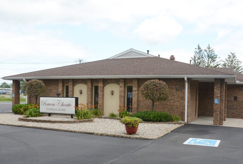 A large brick building with a handicapped parking spot in front of it.