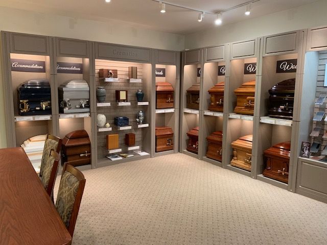 A room filled with lots of coffins and urns on shelves.