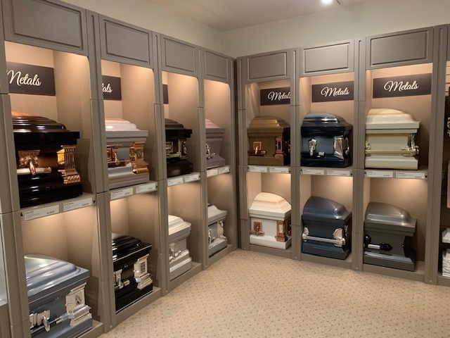 A room filled with lots of coffins on shelves.