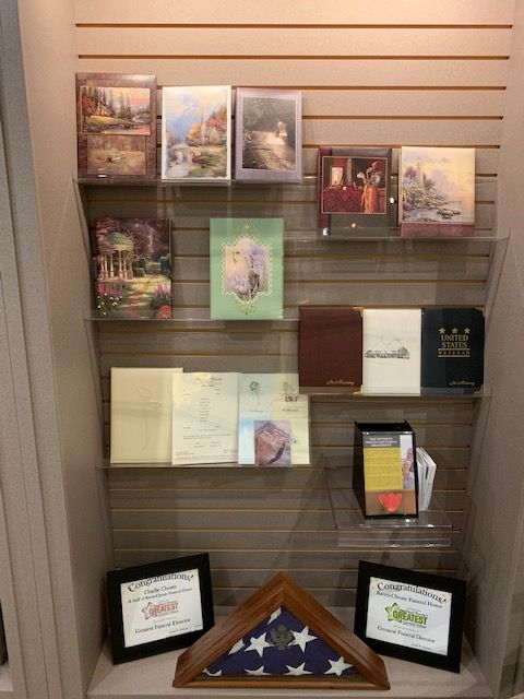 A display of greeting cards and a flag on a shelf