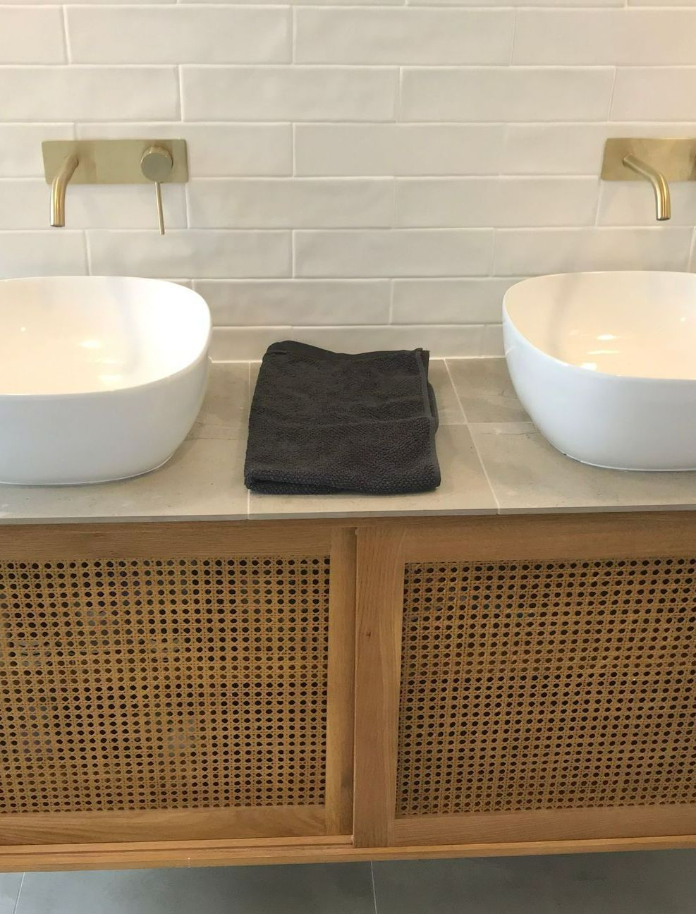 A Bathroom With Two Sinks and a Towel on the Counter — Puzzles Plumbing & Excavations In Koonorigan, NSW