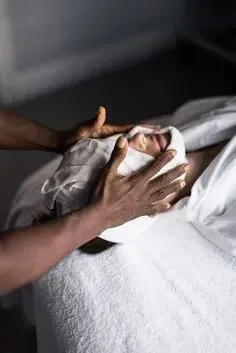A person is getting a facial treatment at a spa