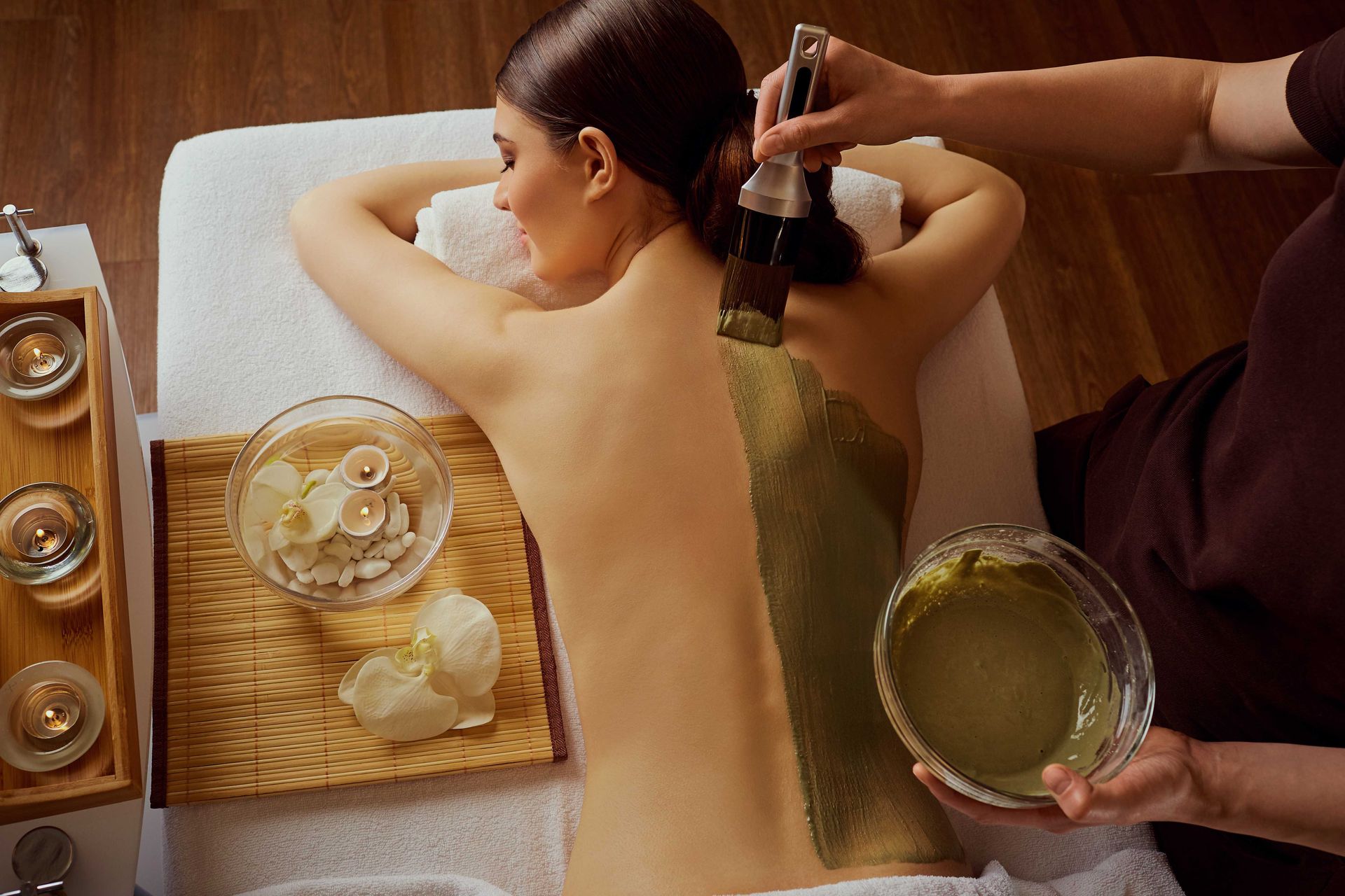 A woman is getting a body massage at a spa