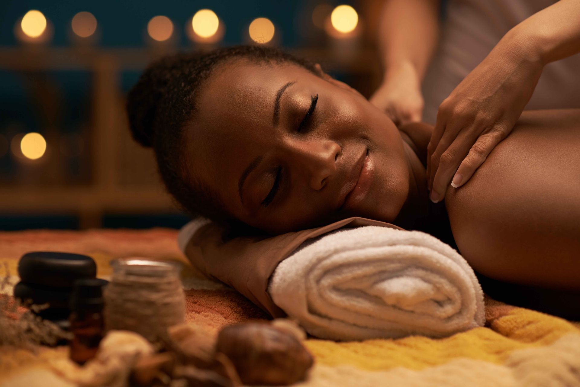 a woman is laying on a bed getting a massage