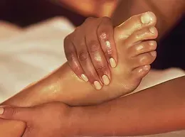 A woman is getting a foot massage at a spa