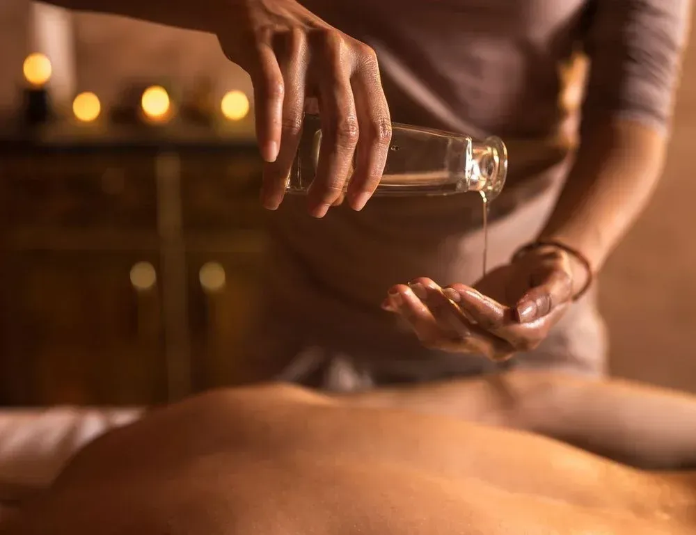 A woman is giving a massage to a man in a spa