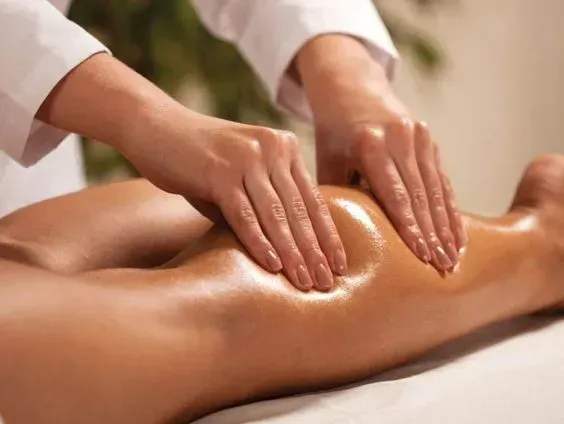 A woman is getting a massage on her leg