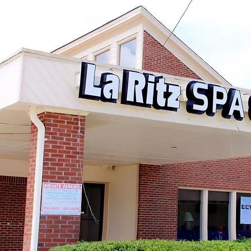A brick building with a sign that says la ritz spa