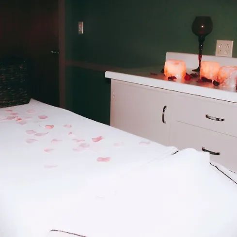 A table with candles and petals on it