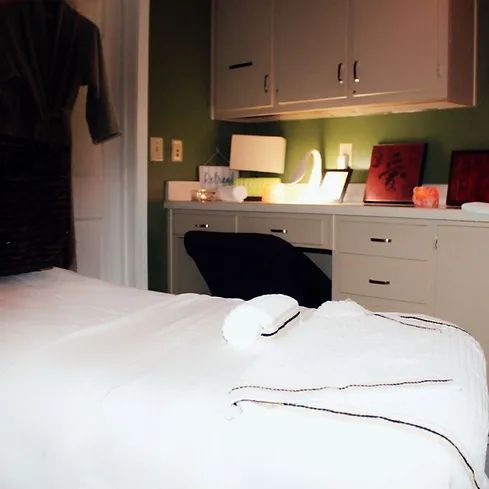 A room with a bed and a desk with a sign that says ' i love you ' on it