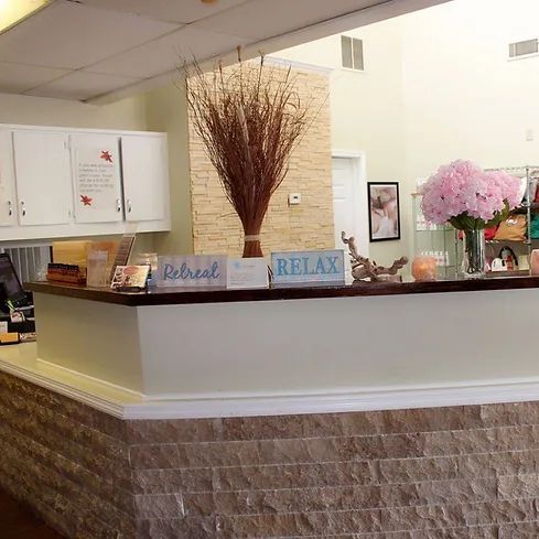 A sign that says relax is on a counter in a room