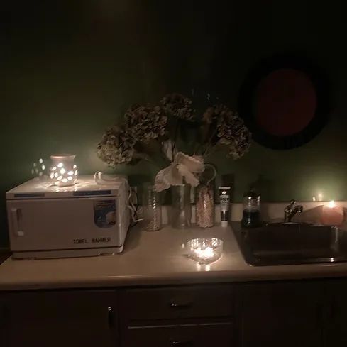 A kitchen counter with a towel warmer and candles on it.