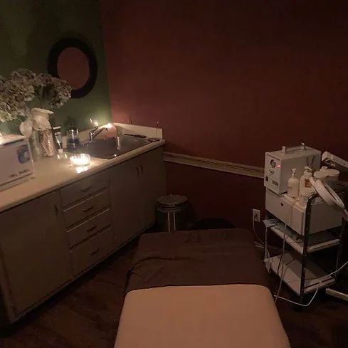 A room with a bed and a sink in it.