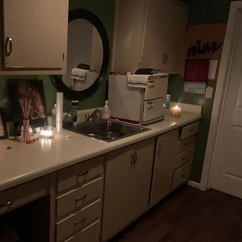A kitchen with a sink and a sign that says relax