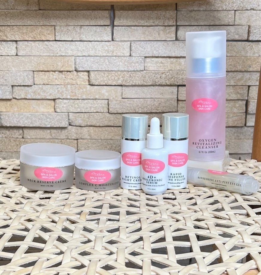 A bunch of pink and white bottles on a table