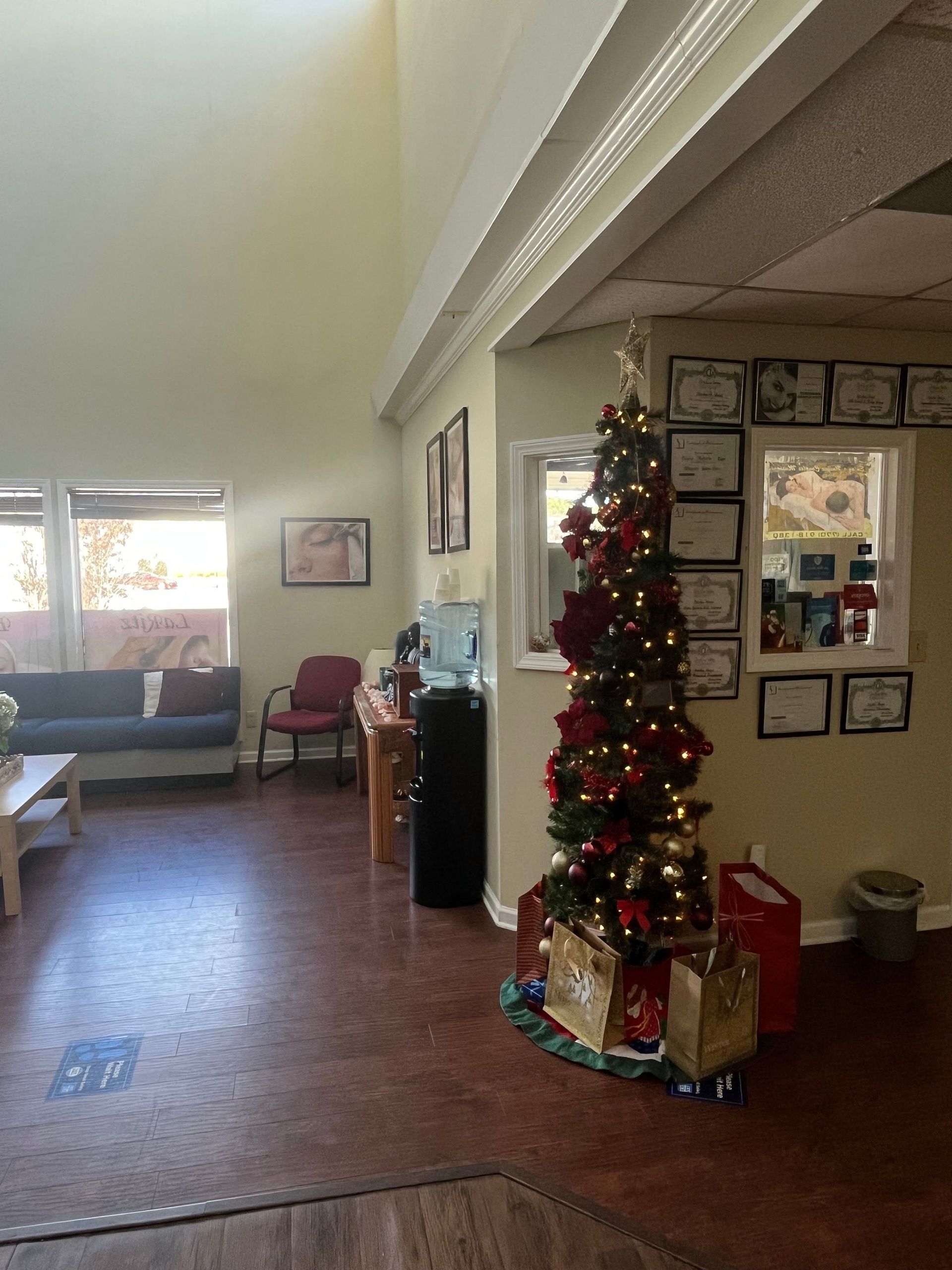 A living room with a christmas tree and a couch