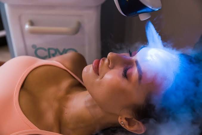 Beautiful young woman enjoying in cryotherapy with cryo sticks or ice globes